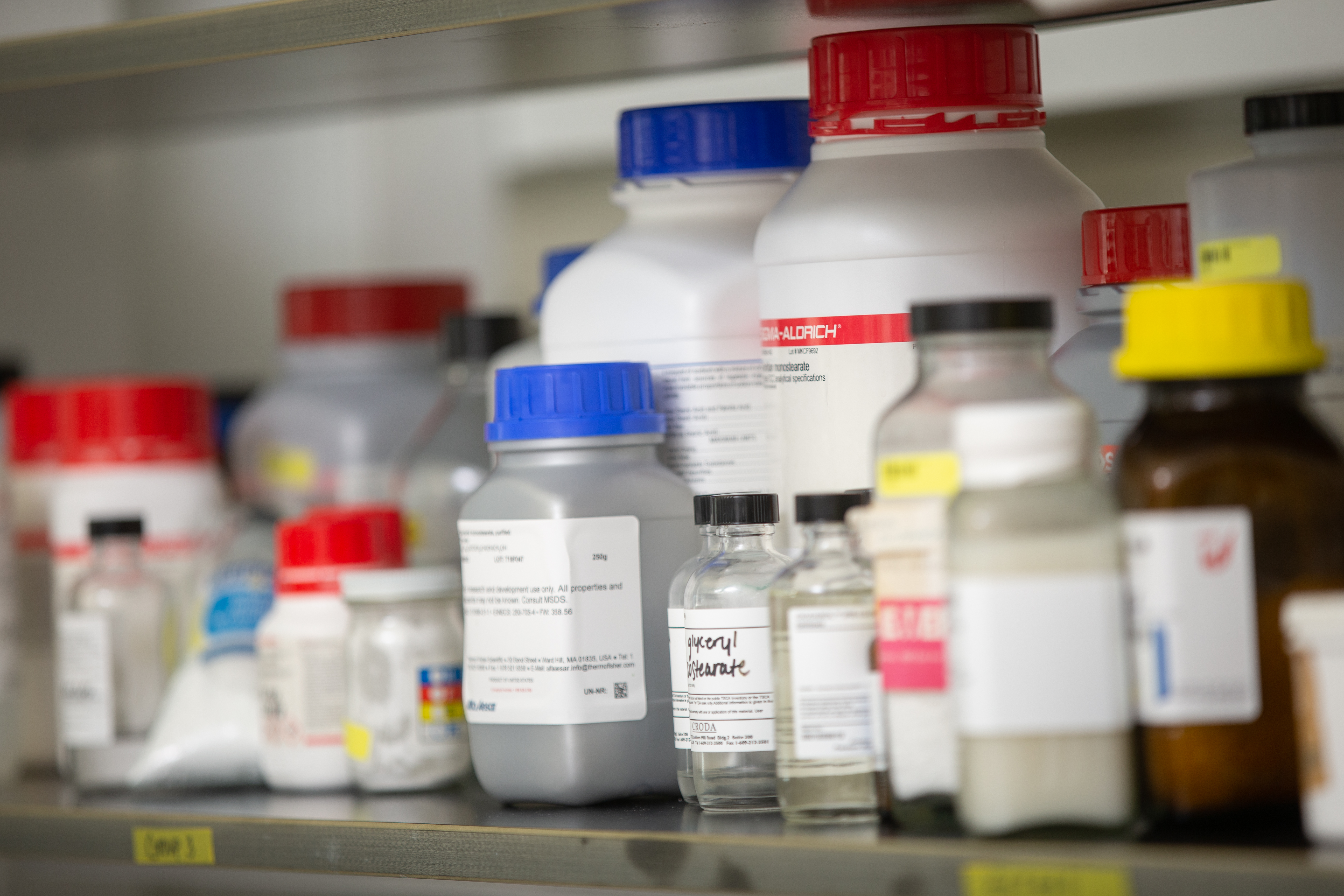 Assorted medicine and lab bottles on a shelf