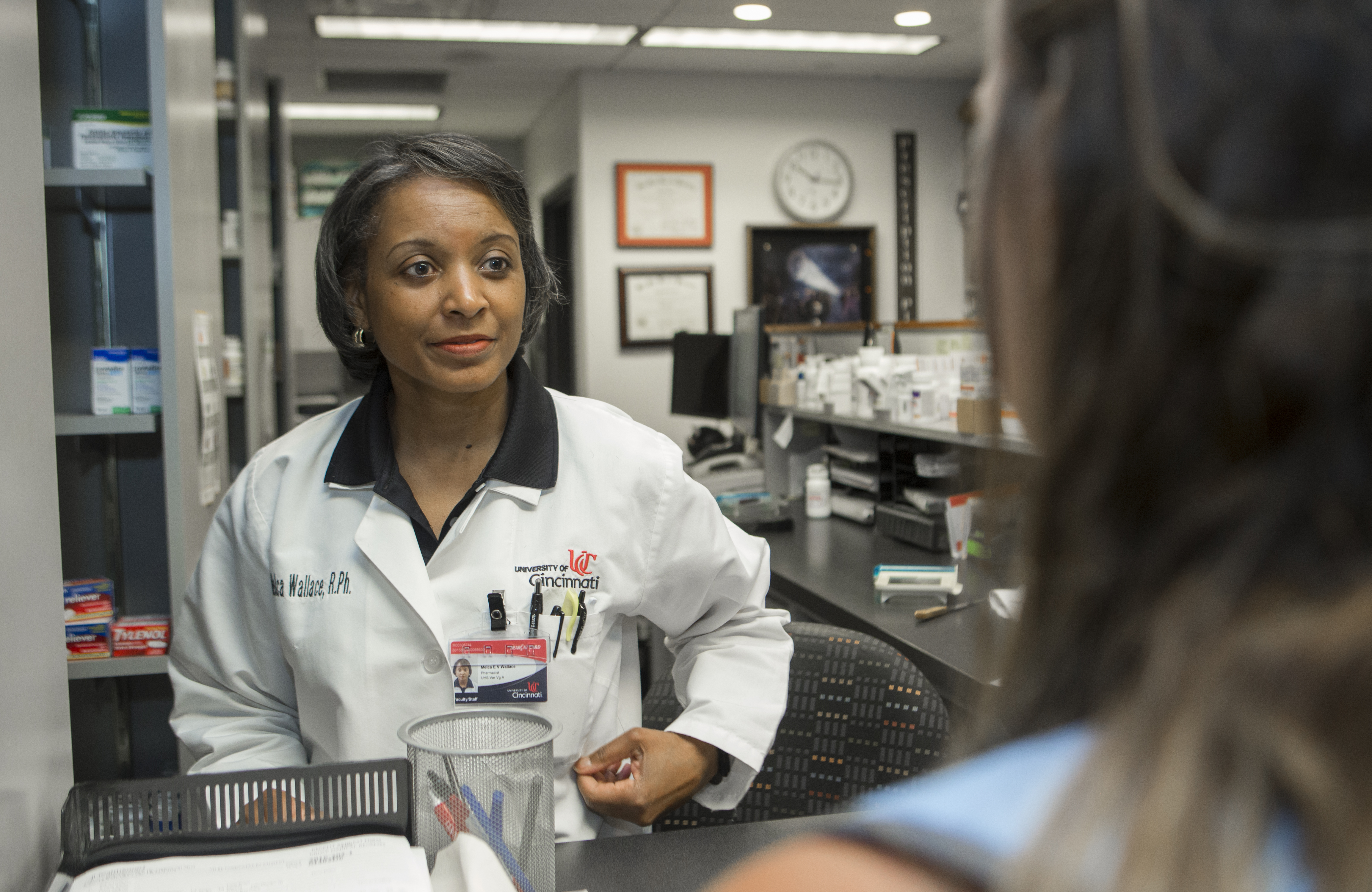 Pharmacist speaking with a customer at a counter