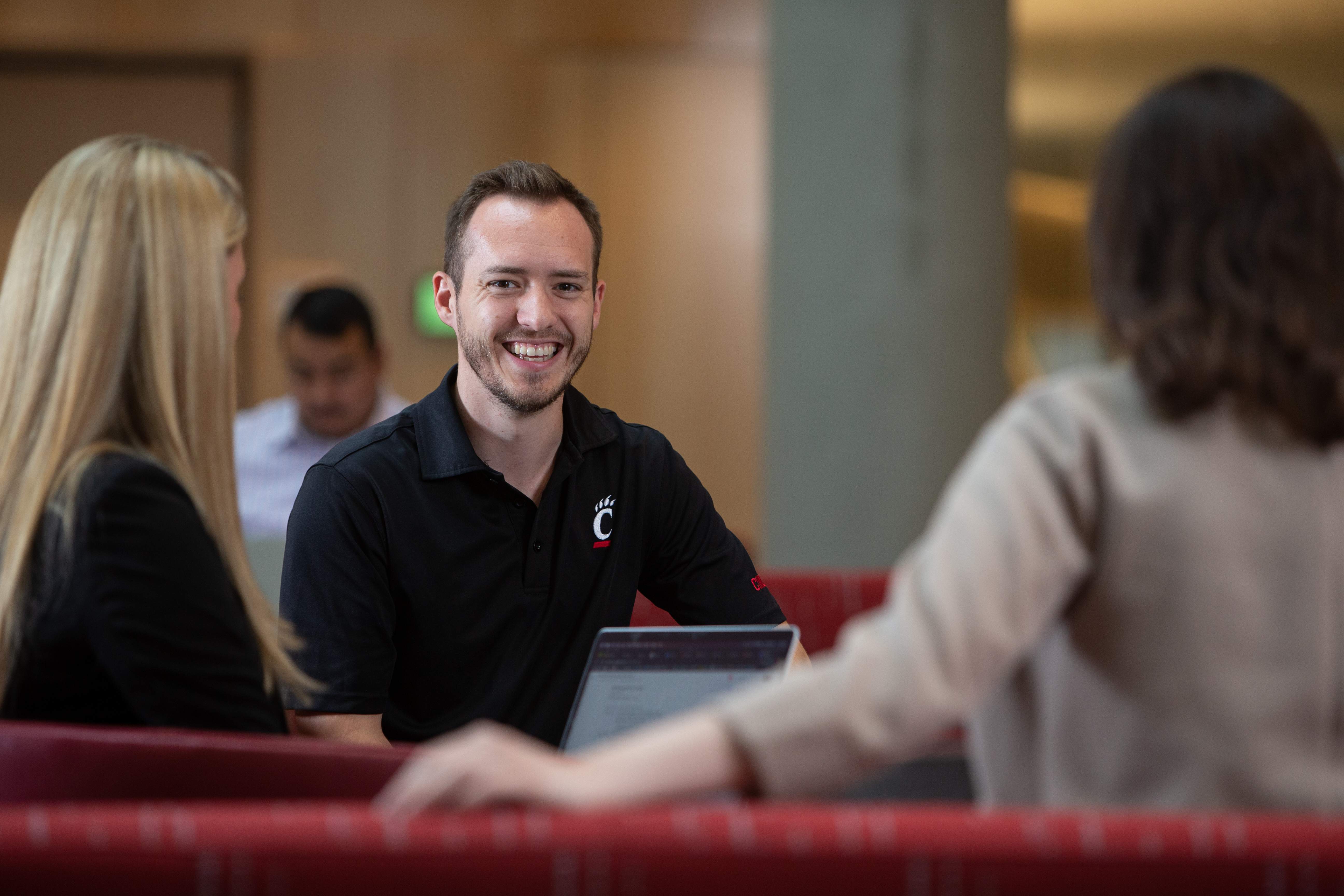 Business professionals collaborating in a team meeting with a laptop in a shared workspace