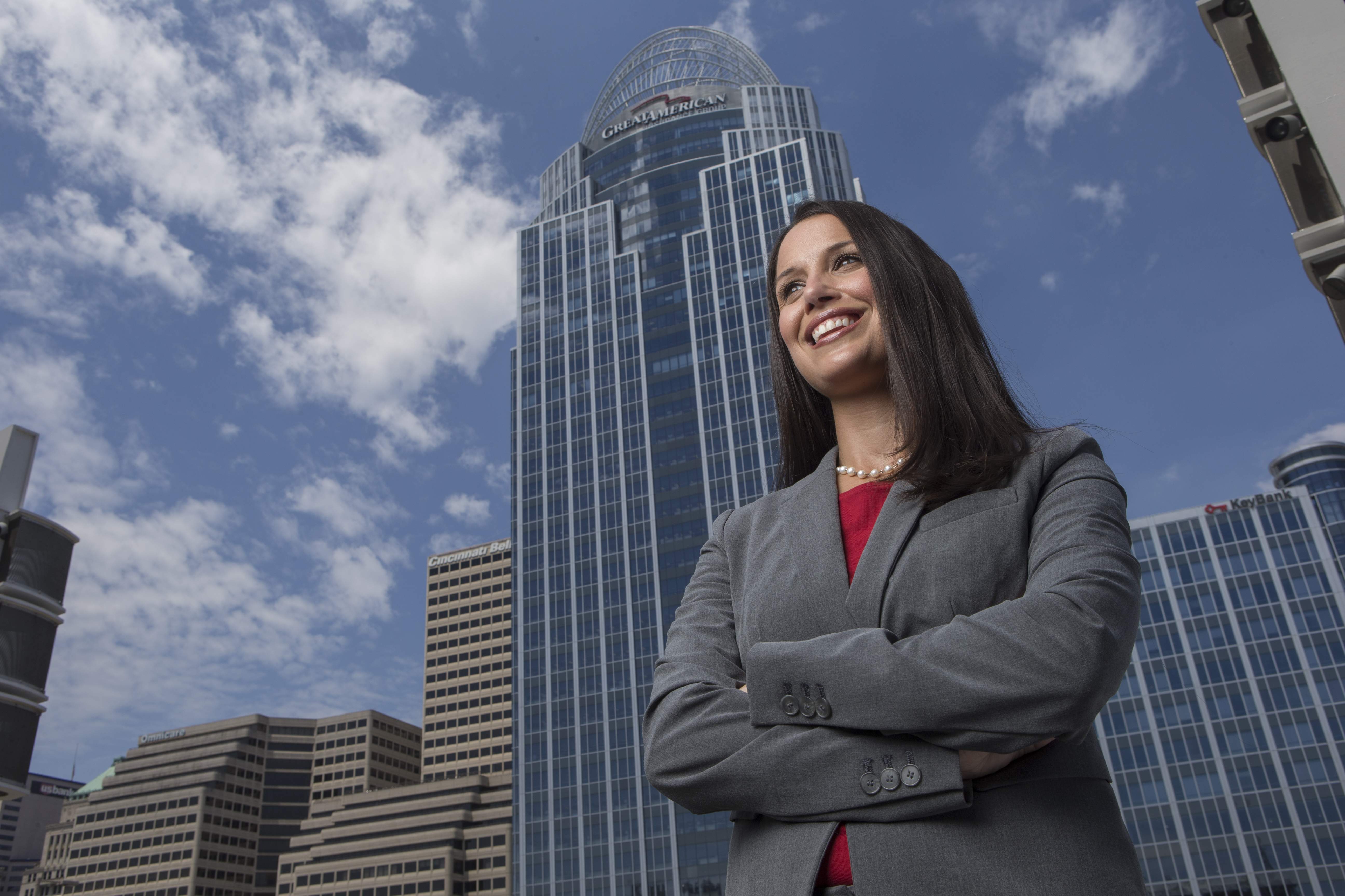 Business professional standing confidently with arms crossed in front of a city skyline