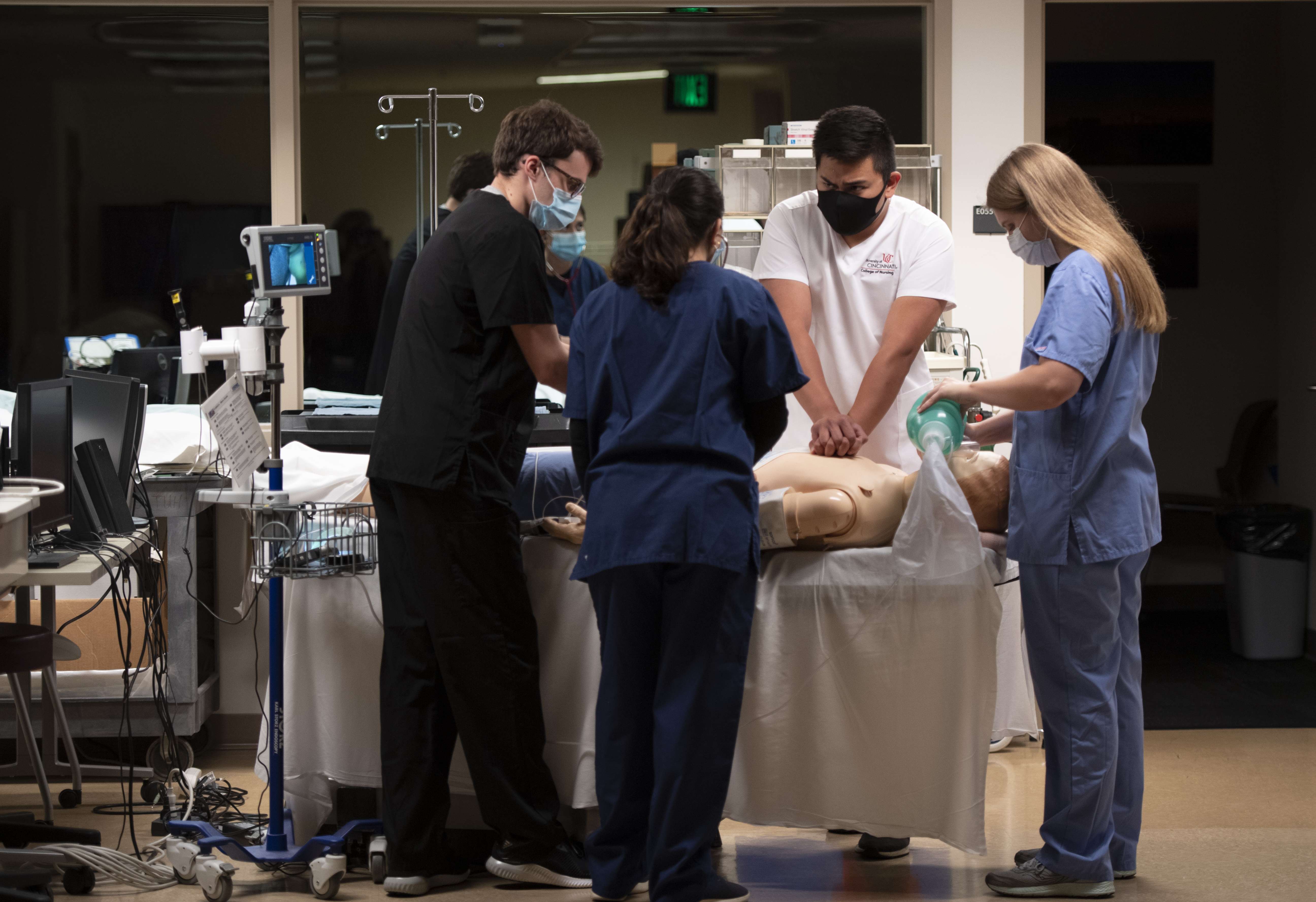 Medical team performing CPR and ventilation on a training mannequin