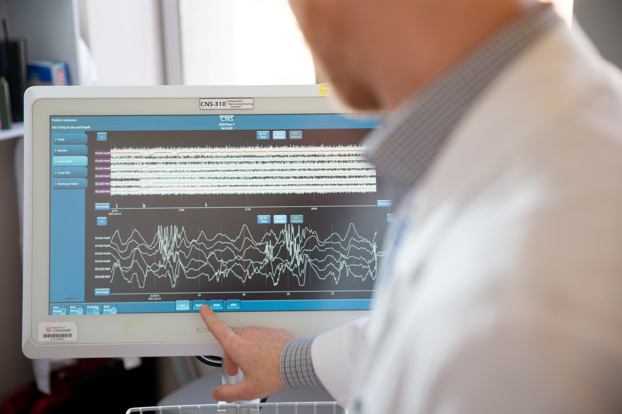 Healthcare professional reviews cardiovascular monitoring data on a medical computer screen